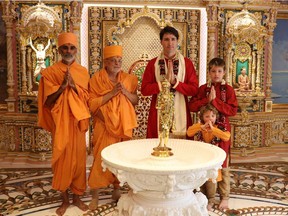 In this photograph released by the Swaminarayan Akshardham Temple on February 19, 2018, Canadian Prime Minister Justin Trudeau (C) and his sons Xavier (R) and Hadrien pose for a photograph.