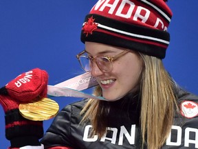 Canada's Cassie Sharpe inspects her gold medal during the ceremony for the freestyle skiing women's halfpipe on Tuesday.