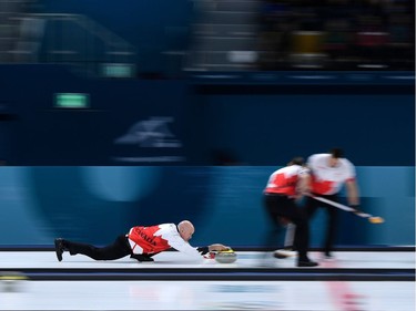 Canada's Kevin Koe throws the stone during the curling men's round robin session between Denmark and Canada during the Pyeongchang 2018 Winter Olympic Games at the Gangneung Curling Centre in Gangneung on February 21, 2018.