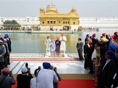 Canada's Prime Minister Justin Trudeau (R), along with his wife Sophie Gregoire Trudeau (L), daughter Ella-Grace (2nd L) and son Xavier (2nd R) pose for a family photo as they pay their respects at the Sikh Golden Temple in Amritsar on February 21, 2018. Trudeau and his family are on a week-long official trip to India.