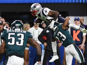 Brandin Cooks (C) of the New Enlgand Patriots attempts unsuccessfully to hurdle over Rodney McLeod (R) of the Philadelphia Eagles during Super Bowl LII at US Bank Stadium in Minneapolis, Minnesota, on February 4, 2018. / AFP PHOTO / TIMOTHY A. CLARYTIMOTHY A. CLARY/AFP/Getty Images