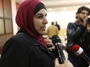 Canadian citizen Jolly Bimbachi, who was being held along with compatriot Sean Moore by a jihadist-dominated alliance in northwest Syria, speaks to the press at the Bab al-Hawa crossing with Turkey on February 5, 2018 after they were released to Turkish authorities.