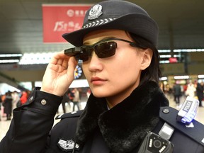 This photo taken on February 5, 2018 shows a police officer wearing a pair of smartglasses with a facial recognition system at Zhengzhou East Railway Station in Zhengzhou in China's central Henan province.