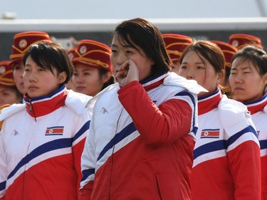 A North Korean athlete wipes her tears away as she sings the national anthem during a welcoming ceremony for the team at the Olympic Village in Gangneung on February 8, 2018 ahead of the Pyeongchang 2018 Winter Olympic Games.