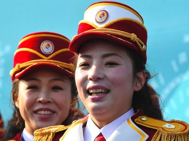 North Korean cheerleaders smile as they prepare to perform before a welcoming ceremony for North Korea's Olympic team at the Olympic Village in Gangneung on February 8, 2018 ahead of the Pyeongchang 2018 Winter Olympic Games.