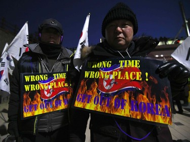 Anti-North Korea protesters hold placards showing a North Korean flag during a rally against planned North Korea's musical concert near the Gangneung Art Centre in Gangneung, the host city of the ice venues for the Pyeongchang Winter Olympic Games, on February 8, 2018. A North Korean orchestra is scheduled to hold two performances at the Gangneung Art Centre on the eve of the opening ceremony of the February 9-25 Pyeongchang Olympics and at the National Theatre of Korea in Seoul on February 11.