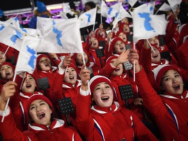Members of the North Korean cheering band wave flags ahead of the opening ceremony of the Pyeongchang 2018 Winter Olympic Games at the Pyeongchang Stadium on February 9, 2018.
