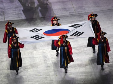 TOPSHOT - Participants perform with South Korea's national flag during the opening ceremony of the Pyeongchang 2018 Winter Olympic Games at the Pyeongchang Stadium on February 9, 2018.