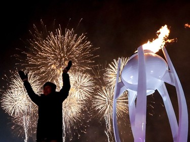 Fireworks erupt as the cauldron is lit with the Olympic flame during the opening ceremony of the Pyeongchang 2018 Winter Olympic Games at the Pyeongchang Stadium on February 9, 2018.