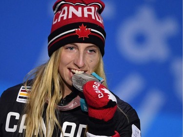Canada's silver medallist Laurie Blouin bites her medal on the podium during the medal ceremony for the women's snowboard slopestyle at the Pyeongchang Medals Plaza during the Pyeongchang 2018 Winter Olympic Games in Pyeongchang on February 12, 2018.