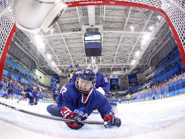 Unified Korea's Kim Heewon falls into the net in the women's preliminary round ice hockey match between Sweden and the Unified Korean team during the Pyeongchang 2018 Winter Olympic Games at the Kwandong Hockey Centre in Gangneung on February 12, 2018.