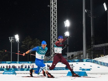 Italy's Federico Pellegrino (L) snatches silver and Russia's Alexander Bolshunov, bronze, as the cross the finish line in the men's cross-country individual sprint classic final at the Alpensia cross country ski centre during the Pyeongchang 2018 Winter Olympic Games on February 13, 2018 in Pyeongchang.