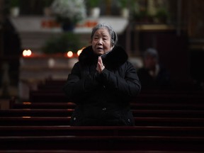A Catholic worshipper prays after an Ash Wednesday mass, which marks the beginning of Lent, at Beijing's government sanctioned South Cathedral on February 14, 2018. Catholic community is awaiting news of whether the Vatican will reestablish ties with Beijing after over 60 years of diplomatic estrangement.