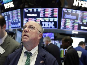 Trader Frederick Reimer works on the floor of the New York Stock Exchange, Tuesday, Feb. 6, 2018. The Dow Jones industrial average fell as much as 500 points in early trading, bringing the index down 10 percent from the record high it reached on Jan. 26. The DJIA quickly recovered much of that loss.