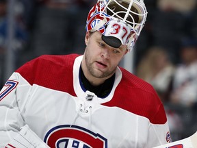 Montreal Canadiens goaltender Antti Niemi pulls up his helmet during a time out against the Colorado Avalanche in the first period of an NHL hockey game Wednesday, Feb. 14, 2018, in Denver.