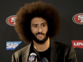 Colin Kaepernick talks during a news conference in December 2016.