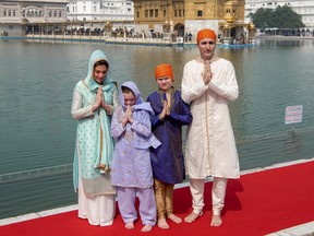 Canadian Prime Minister Justin Trudeau, right, his wife Sophie Gregoire Trudeau, left, their daughter Ella Grace, second left, and son Xavier greet in Indian style during their visit to Golden Temple, in Amritsar, India, Wednesday, Feb. 21, 2018. Trudeau is on a seven-day visit to India. (Public Relations Office Govt. Of Punjab via AP) ORG XMIT: ASR102