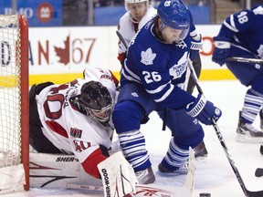 Ottawa Senators goaltender Robin Lehner makes a save on Toronto Maple Leafs forward Mike Zigomanis (26) during second period pre-season NHL hockey action in Toronto on September 21, 2010. A former Toronto Maple Leafs hockey player who lost a promotional gig after nude pictures of himself surfaced on the internet had his breach-of-contract award upheld on Tuesday. In affirming the $162,500 in damages previously awarded to Mike Zigomanis, the Ontario Court of Appeal rejected an attempt by D'Angelo Brands to argue the images originally shared by the hockey player with his then-girlfriend offended the community.