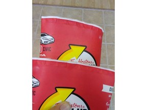 Adam Peddle says he has a growing collection of Tim Hortons Roll up the Rim cups, but they're not winners -- there's no message at all under the rim as shown in this handout image.