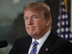 President Donald Trump pauses as he arrives to speak about the mass shooting at a South Florida High School from the White House, Thursday, Feb. 15, 2018, in Washington.