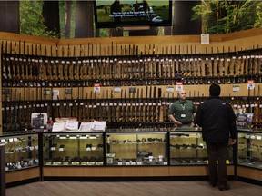 A customer looks at guns at a Dick's Sporting Goods