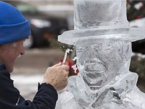 Peter Vogelaar from Nelson, B.C. works on an ice sculpture of The Tragically Hip's late frontman, Gord Downie in downtown Kingston