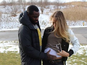 Melissa Bishop and Osi Nriagu show off her baby bump in a photo posted online Thursday.