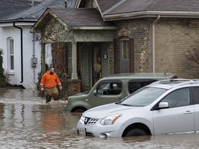 About 5,000 people were evacuated from their homes in Brantford on Wednesday when the city declared a state of emergency due to flooding from the Grand River. A man walks through the flood waters at Grand River Street and Scarfe Avenue.