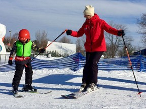 Sen. Nancy Greene Raine gives a little help to a young skier while at Jacques Cartier Park on Thursday, Feb. 8, 2018.