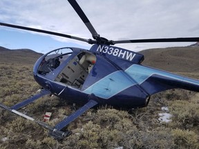 In this photo taken Monday, Feb. 12, 2018, and provided by the Wasatch County Sheriff's Office is a research helicopter that was brought down by a leaping elk in the mountains of eastern Utah. Wasatch County authorities say the elk jumped into the chopper's tail rotor as the craft flew low, trying to capture the animal with a net. The two people on board weren't seriously hurt, but wildlife officials say the elk died of its injuries. The state-contracted Australian crew had been trying to capture and sedate the elk so they could collar it and research its movements about 90 miles east of Salt Lake City.