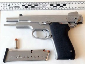 One of two handguns seized in a drug-related arrest in the west end Wednesday night. Four men have been charged.