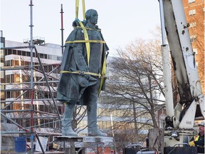 Contractors remove the statue of Edward Cornwallis, a controversial historical figure, in a city park in Halifax on Wednesday, Jan. 31, 2018. Cornwallis, the military officer who founded Halifax in 1749, offered a cash bounty to anyone who killed a Mi'kmaw person.