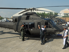 A Philippine Air Force chaplain blesses a newly-delivered Bell 412 helicopter during a christening ceremony in Manila in 2015.