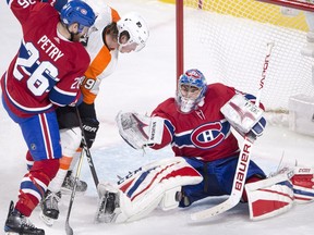 Montreal Canadiens goaltender Charlie Lindgren (39) makes the save on Philadelphia Flyers centre Nolan Patrick (19) as Montreal Canadiens defenceman Jeff Petry (26) moves in during third period NHL hockey action Monday, February 26, 2018 in Montreal.