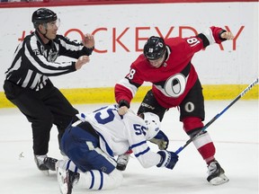 Linesman Derek Amell rushes in as Senators winger Ryan Dzingel punches Maple Leafs defenceman Andreas Borgman during a fight in a Jan. 20 game in Ottawa.