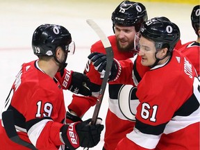 The Ottawa Senators' Mark Stone (61) celebrates his goal with teammates Derick Brassard (19) and Zack Smith during the first period against the New York Rangers at the CTC on Saturday, Feb. 17, 2018.