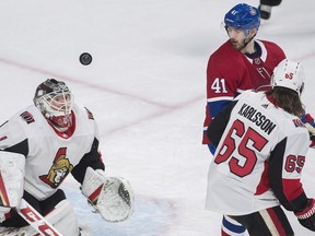 Montreal Canadiens left wing Paul Byron (41) moves in on Ottawa Senators goaltender Mike Condon (1) as defenceman Erik Karlsson (65) defends during first period NHL hockey action in Montreal, Sunday, February 4, 2018.