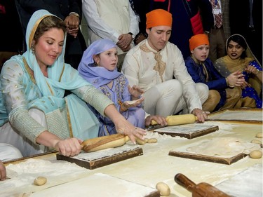 Canadian Prime Minister Justin Trudeau, third left, and his wife Sophie Gregoire Trudeau, left, make Rotis or Indian flat bread during their visit to Golden Temple, in Amritsar, India, Wednesday, Feb. 21, 2018. Trudeau is on a seven-day visit to India.
