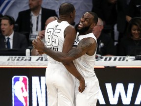 Team LeBron's Kevin Durant, left, of the Golden State Warriors, celebrates with Team LeBron's LeBron James, of the Cleveland Cavaliers, during the NBA All-Star game in Los Angeles on Sunday, Feb. 18, 2018.