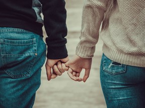 A couple holding hands.