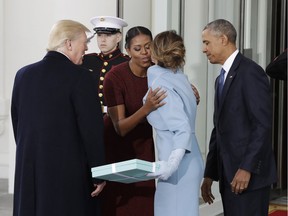 In this Jan. 20, 2017 file photo, first lady Michelle Obama, flanked by President Barack Obama and then President-elect Donald Trump, greets Melania Trump at the White House in Washington.