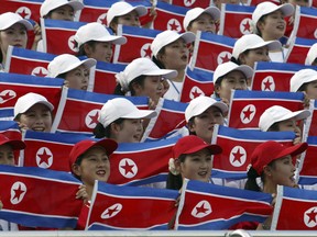 North Korean women hold national flags to cheer at the Daegu Universiade Games in Daegu, south of Seoul, South Korea on Aug. 28, 2003.