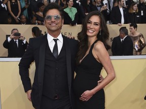 FILE - In this Jan. 21, 2018 file photo, John Stamos, left, and Caitlin McHugh arrive at the 24th annual Screen Actors Guild Awards at the Shrine Auditorium & Expo Hall in Los Angeles. Police say burglars stole $165,000 in jewelry from a room at the Beverly Hills Hotel that was occupied by McHugh. A police statement says Caitlin McHugh was away from her room Friday, Feb. 2, when a crook or crooks got in and took several items of jewelry. It's unclear how the burglars got inside. There's no indication of forced entry.