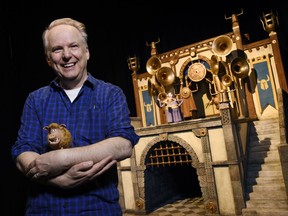 In this Feb. 8, 2018 photo, Nick Park, director of the stop-motion animated film "Early Man," and the voice of the wild boar character Hognob, cradles the puppet as he poses in front of the film's Royal Box set at the Beverly Hilton in Beverly Hills, Calif. The film opens nationwide on Friday, Feb. 16.