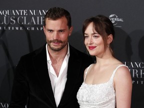 FILE - In a Tuesday, Feb. 6, 2018 file photo, Jamie Dornan, left, and Dakota Johnson pose during a photocall for the world premiere of 'Fifty Shades Freed - 50 Nuances Plus Claires' at Salle Pleyel in Paris. "Fifty Shades Freed" has topped the North American box office in its first weekend in theaters. Universal Pictures estimates Sunday, Feb. 11, 2018 that the final chapter in the Christian Grey and Anastasia Steele saga has earned $38.8 million, which is down significantly from the first film's $85.2 million debut and the sequel's $46.6 million opening.