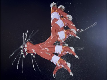 A multiple exposure captures Hanna Huskova of Belarus during her first run of the women's aerials finals at the Phoenix Snow Park during the Pyeongchang 2018 Winter Olympic Games in South Korea, Friday, Feb. 16, 2018.