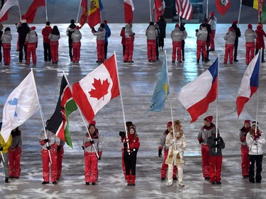 Canadian short-track speed skater Kim Boutin leads team Canada into the Olympic stadium carrying the Canadian flag during the closing ceremonies at the 2018 Pyeongchang Olympic Winter Games in Pyeongchang, South Korea, on Sunday, February 25, 2018.