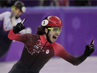 Samuel Girard, of Canada, celebrates as he crosses the finish line to win the gold medal in men's 1000 meters short track speedskating final in the Gangneung Ice Arena at the 2018 Winter Olympics in Gangneung, South Korea, Saturday, Feb. 17, 2018.