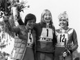 Canadian skier Kathy Kreiner (C), West German Rosi Mittermaier (L) and French Daniele Debernard smile after the women's giant slalom at the Winter Olympic Games in Innsbruck. Kreiner won the gold medal in front of Mittermaier (silver) and Debernard (bronze).