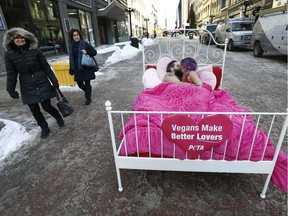 Derek Rombeiro and Jedranne Martel take part in a PETA protest on O'Connor Street in Ottawa Tuesday Feb 13, 2018. PETA wanted to let the world know that vegans make better lovers.